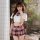 Woman wearing plus size sexy jk uniform set with white crop top and red plaid pleated mini skirt for role play.