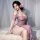 Woman wearing plus size sexy purple lace bodysuit, sultry sm sleepwear nightdress with floral hair accessory.