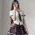 Woman wearing a plus size sexy jk uniform set with a white shirt, plaid tie, and skirt for schoolgirl role play.