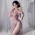 Woman in plus size sexy lace purple bodysuit, sultry sm sleepwear nightdress with high slit and floral details.