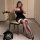 Woman in black adjustable rope-tie cami nightgown with lace stockings, posing on chair. plus size sexy lingerie set.