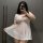 Curvy woman wearing plus size sensual lingerie set, featuring a sheer white maid-style sleepwear with lace trim and ruffled h...