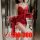 Woman modeling a red plus size sexy lingerie set with lace details and matching robe, elegant sleepwear for couples.