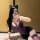 Curvy woman in purple lace lingerie set with cat ears, taking a mirror selfie.