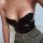 Sexy black pu bodysuit with plunging neckline, stylish gold necklace, trendy fall winter outfit for women.