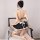 Woman wearing 2021 sexy maid costume set, featuring cute black and white lingerie with playful bow details.