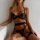 Elegant black lace underwire push-up bra set with intricate embroidery, paired with matching cross-tie garter sets for a styl...