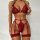 Woman modeling red lace lingerie set with cross-design garter belt and matching bra from 2023 luxury european collection.