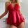 Woman wearing red lace and satin lingerie set with bow detail, featuring sheer top and matching shorts.
