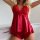Woman wearing red lace and satin lingerie set with bow detail, featuring sheer panels and flared hem.
