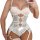 Woman wearing white lace sheer bodysuit set with garter straps and delicate floral embroidery, holding a glass.