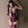 A woman poses in a purple sensual lingerie set featuring lace details, open-crotch design, and stockings, perfect for women s...