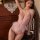 Woman modeling pink sensual lace bodysuit 2025, backless low-cut one-piece lingerie with floral lace and bows.