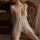 Woman wearing white lace sleep dress with ruffles and bow details, seated on ornate chair — flirty pure-temptation lingerie n...