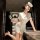 Woman in 2025 sexy nurse costume set posing with wine glass, white uniform and cap for cosplay & role play.