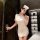 Woman wearing 2025 sexy nurse costume set – authentic white nurse uniform for cosplay & role play, holding wine glass.