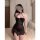 A woman models a black sheer mesh lace bralette set with underwire and push-up pads, featuring a halter neck design and ruche...