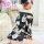 A woman wearing a black floral print robe with off-the-shoulder design, tied waist, and lace details, suitable for romantic l...
