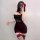 A woman poses in a black sheer slip dress adorned with red roses, paired with thigh-high stockings featuring garter straps, c...