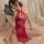 A woman poses elegantly in a red lace cheongsam sleepwear set featuring sheer mesh, high slit, and provocative design element...