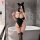 Woman in black nightsigh nightseduce bodysuit with cat ears, posing by bathtub in lace sleepwear uniform.