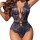 Woman wearing navy blue lace bodysuit with deep v neckline and floral pattern, ultra-thin mini design.