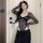 Woman modeling pure & seductive lace bodysuit - style long sleeve sexy matching set for women with black pants.