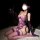 Woman wearing purple lace backless lingerie set with sheer mesh bra, steel underwire, and matching bodysuit.