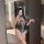 Woman wearing rabbit girl lingerie set, sheer black open-crotch bodysuit with white lace trim and bunny ears.
