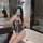 Woman wearing rabbit girl lingerie set - sheer open-crotch bodysuit with bunny ears, posing in bathroom mirror selfie.