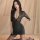 Woman wearing black lace lingerie set with short sleeves, deep v-neck, and sheer stockings; seductive sleepwear or nightclub ...