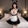 Woman wearing plus size sexy lace bunny girl costume with sheer mesh, ruffled trim, and maid apron in bedroom setting.