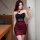 Woman in black and red sheer mesh bodycon dress with 3d floral halter top, taking a mirror selfie.