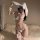 Woman wearing white bunny lingerie set with deep v bra, ruffled panties, and fluffy ears for a seductive costume look.