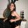 Woman wearing xiyun bunny costume lingerie set – sexy sheer bodysuit with bunny ears, posing by ornate mirror and black decor...