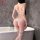 Woman wearing white nightsigh lace bodysuit with open-crotch, cut-outs and mesh in bathroom.