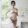 Woman modeling suoqing pearl bikini set with lace butterfly bra, matching panty, and thigh-high stockings in bright room.