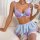 Woman modeling purple lace lingerie set with bow details, featuring bra and ultra-short skirt.