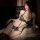 Woman wearing leopard print cat lingerie set, sexy sleepwear with halter top and garter straps, seductive costume outfit.