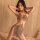 Woman wearing glamorous night lady lace bodysuit set, sheer strap dress with sparkling mesh design for club.