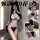 Model wearing qingruohan black and white lingerie set with cat ears, featuring a strappy bra and thong.