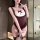 Woman modeling a burgundy and white plus size bunny costume bodysuit with ruffles, bow detail, and lace thigh-highs in a mode...