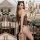 Woman wearing hot cat-themed sexy lingerie bodysuit – black fishnet mesh one-piece with leopard print accents and cat ears, p...