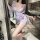 Woman wearing qqny pure allure sleepwear set, elegant sheer lingerie with butterfly print and sash tie.