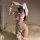 Woman wearing white bunny lingerie set with deep v bra, ruffled panties, and fluffy ears for a seductive costume look.