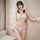 Woman wearing adorable deep v bunny girl lingerie set with hood, bow, and ruffled 3-piece sexy costume for women.