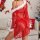 Woman wearing red lace sheer robe with white fur trim, part of a 3-piece christmas lingerie set, in festive holiday decor.