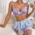 Woman modeling purple lace lingerie set with bow details, featuring bra and ultra-short skirt.