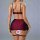 Woman modeling french-style lace lingerie set, featuring a burgundy bra, high-waisted girdle with black lace sides, and match...