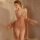 Woman wearing manyan lingerie set with lace cami dress, sheer sleepwear gown and matching robe in soft pink tones.